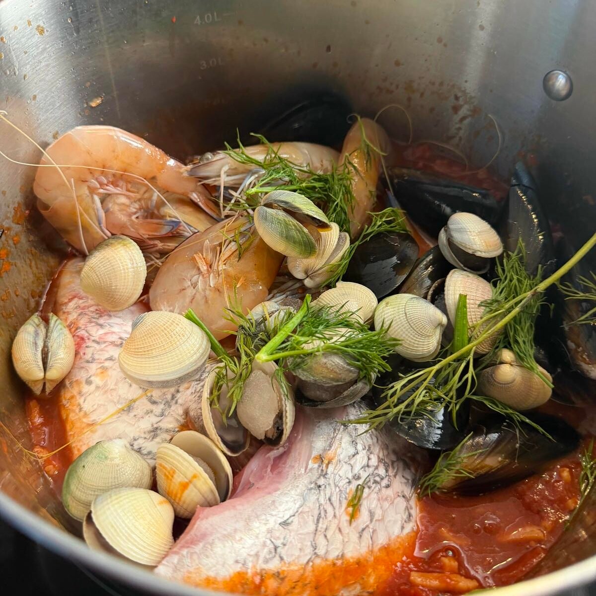 Adding the seafood to the tomatoes sauce